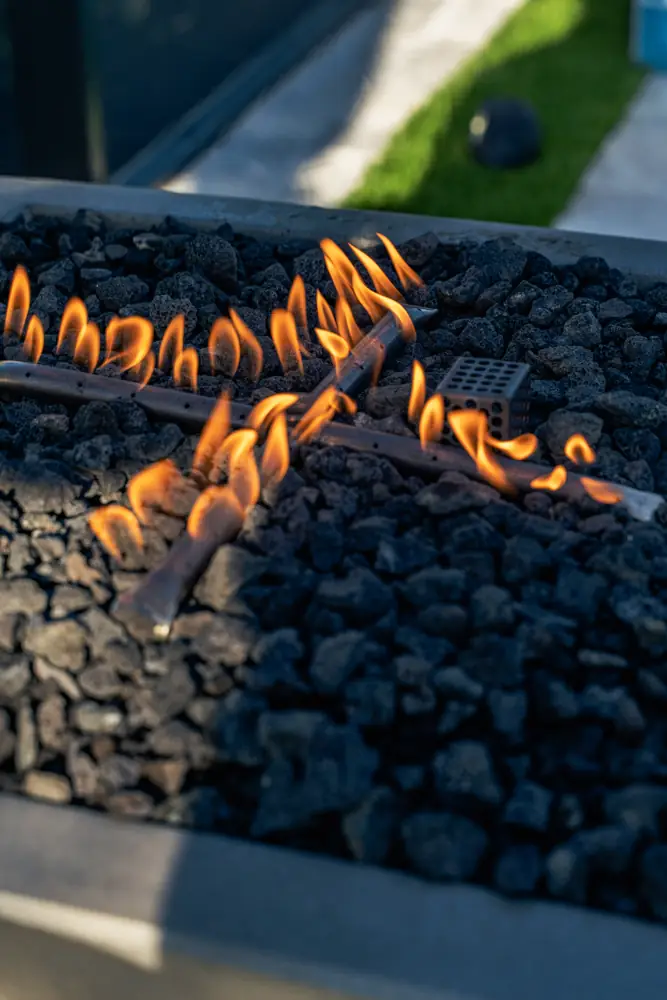 Gas fire pit flames over lava rock