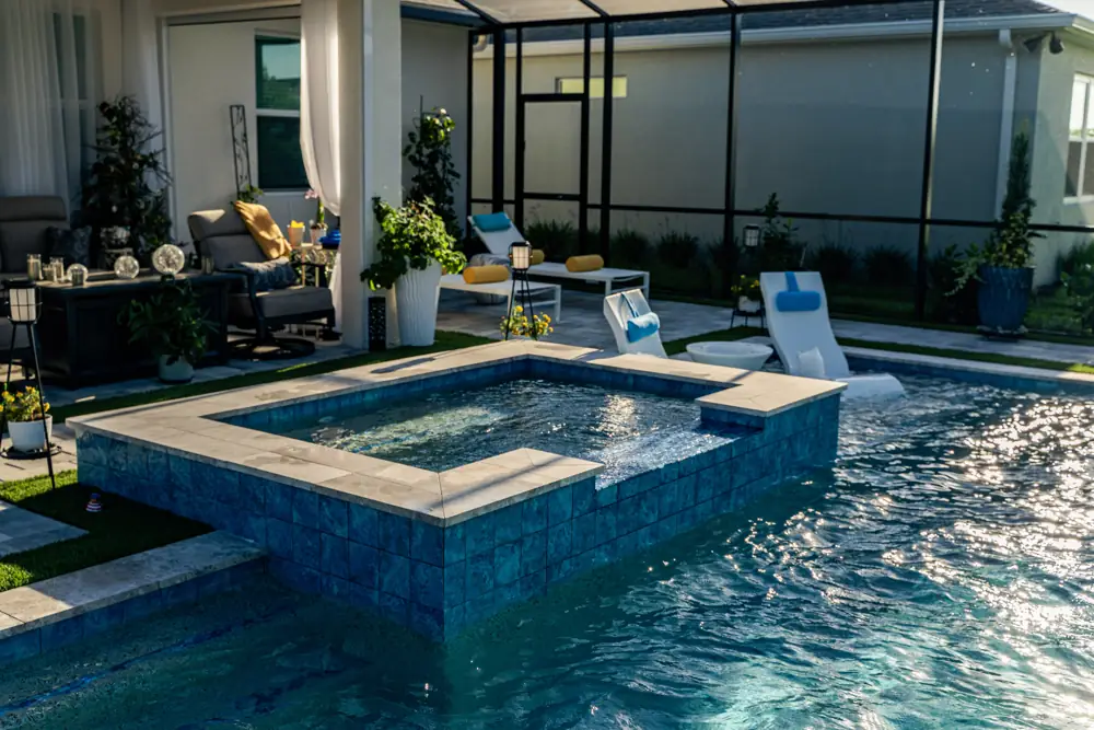 Raised spa and pool beside covered lanai seating