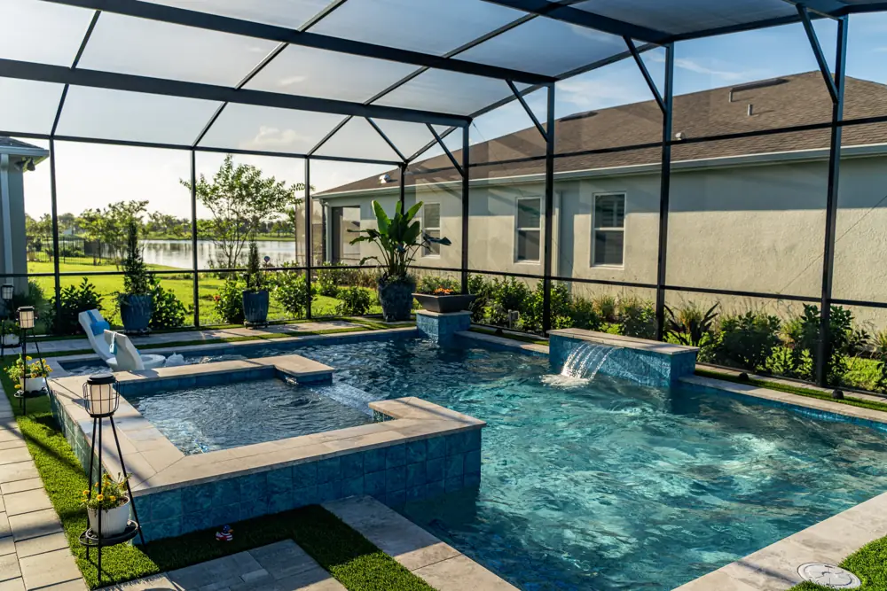 Screened pool and spa with waterfall and lake view