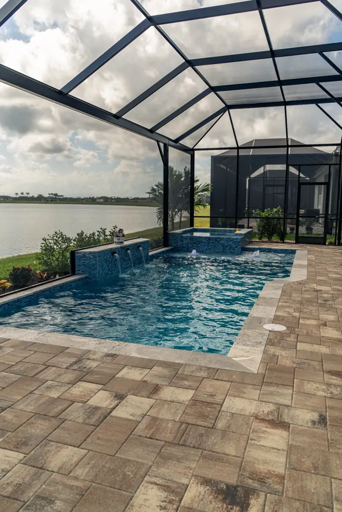 Screened lakeside pool and spa with paver deck