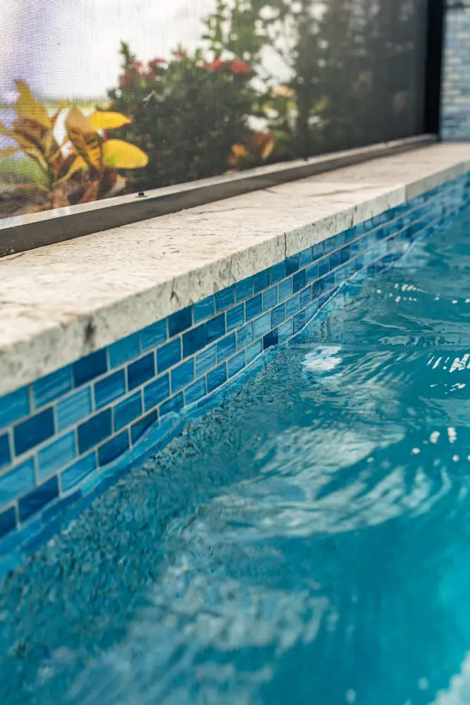 Waterline glass tile and travertine coping