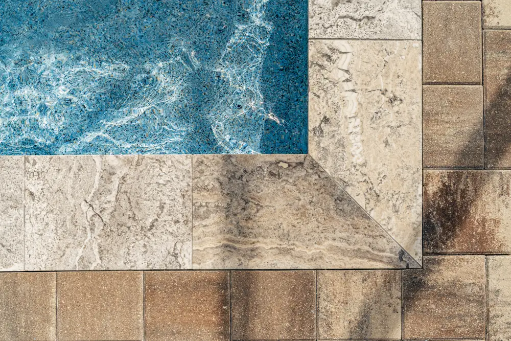 Pool corner with travertine coping and pavers from above — Clermont, Florida