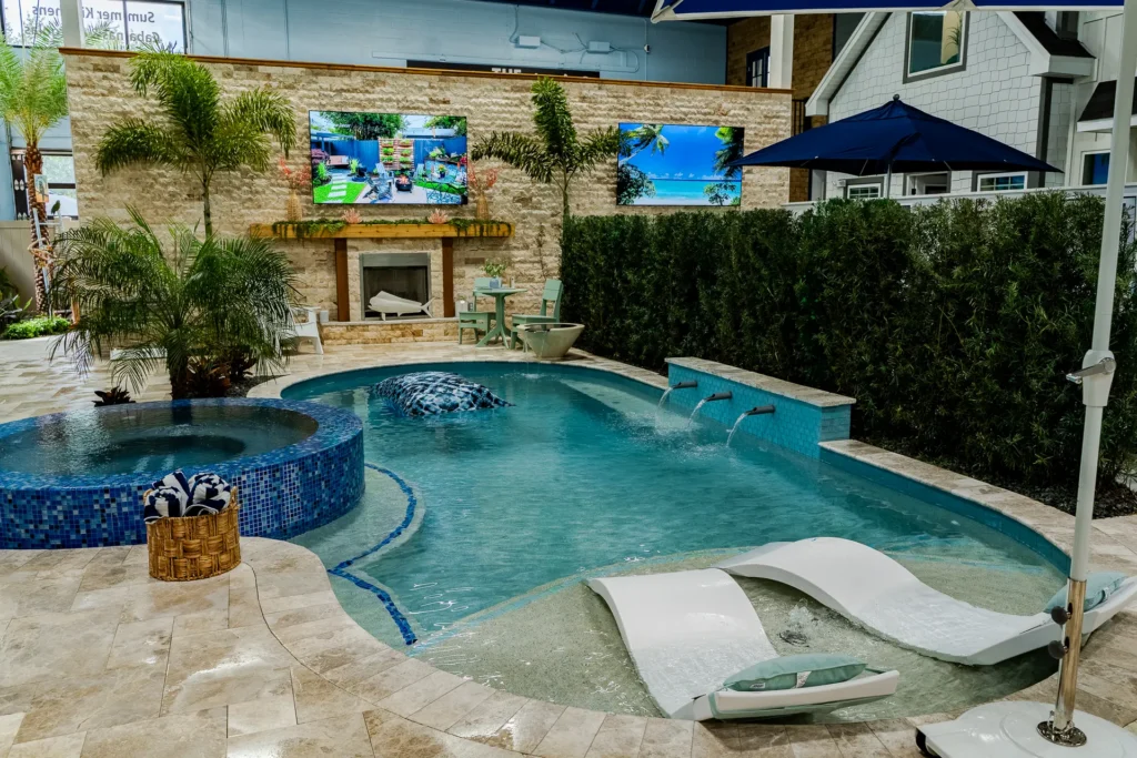 The Design Center display pool and spa with stone fireplace wall