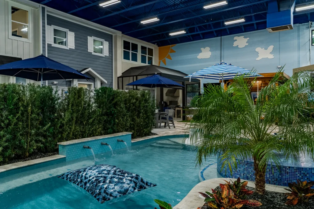 Display pool, waterfall wall, and model home facades inside the showroom
