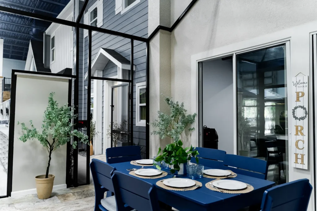 Porch dining vignette beside the model home facades
