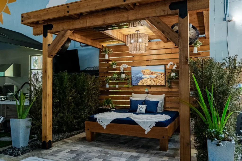 Cedar pergola cabana with daybed, chandelier, and TV