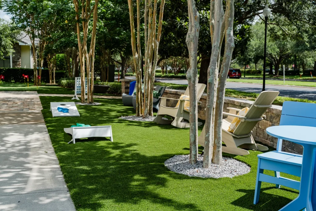 Arriving at the Design Center — front lawn with turf, lawn games, and Adirondack rockers